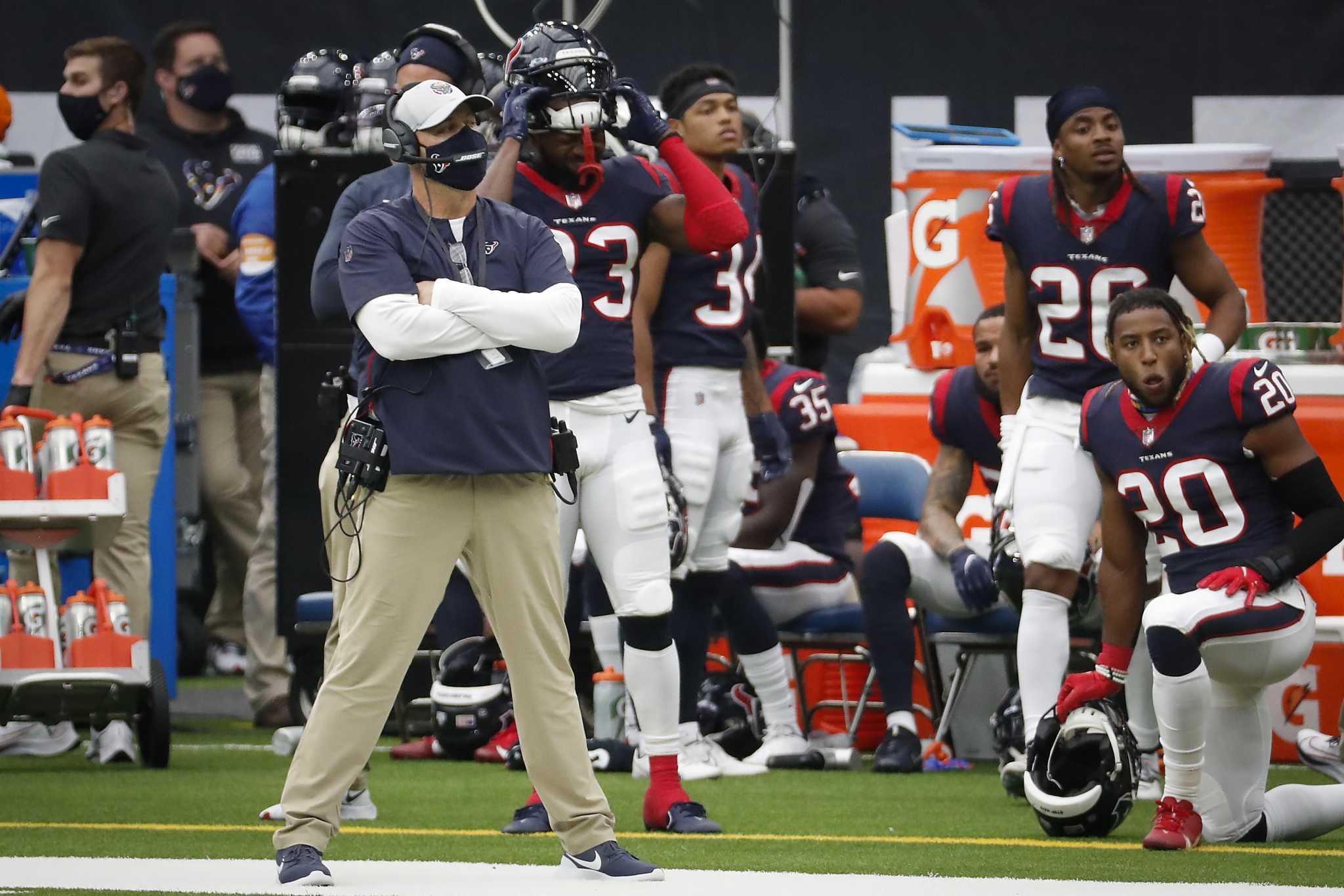 Houston Texans head coach Bill O'Brien talks on his head set next to  running back Carlos Hyde (23) during the second half of an NFL football  game against the Kansas City Chiefs