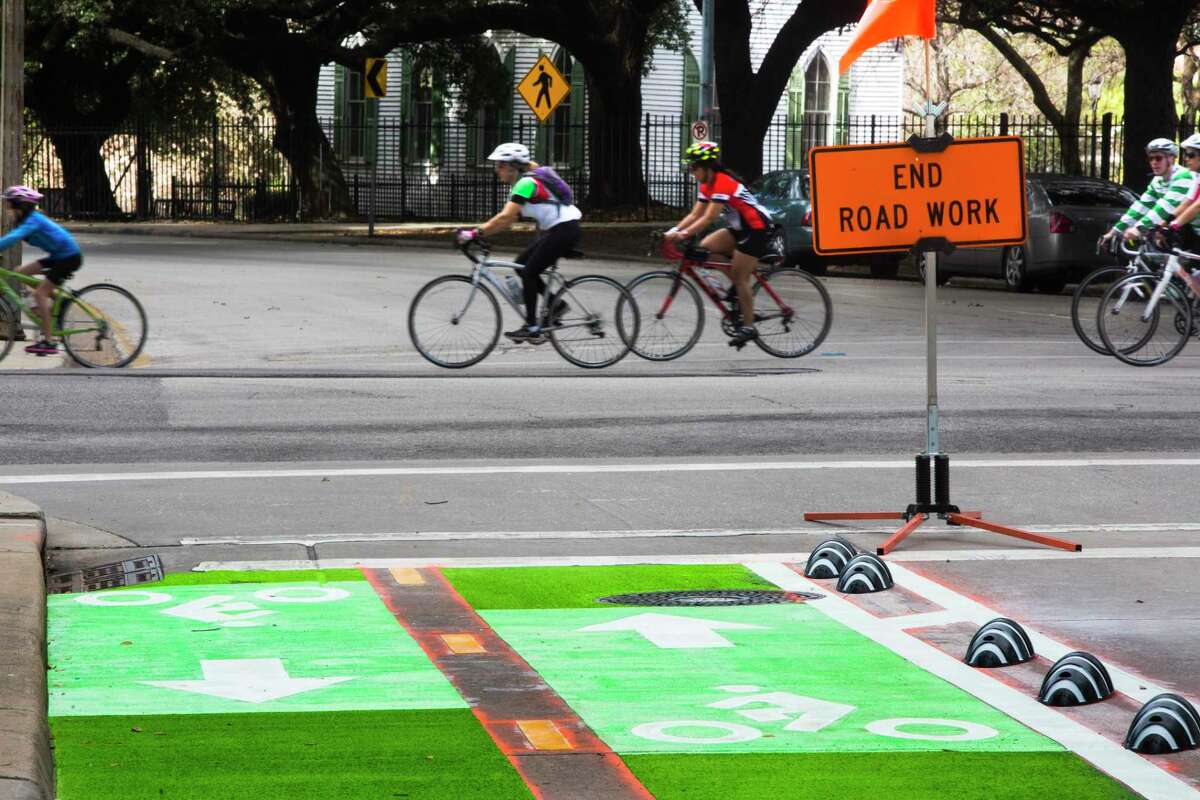 Cyclists ride by the bike lanes in downtown Houston, which were built in 2015.