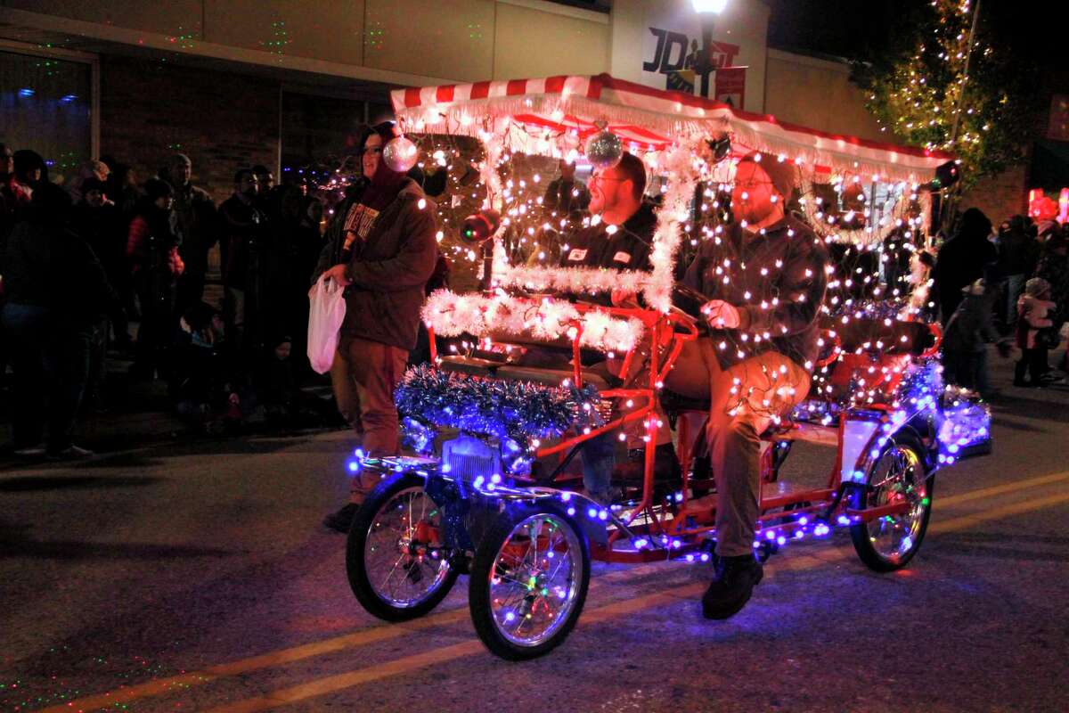 Last year, hundreds of area residents gathered to watch floats decorated in twinkling Christmas lights stroll down Michigan Avenue. Featured is a photo from last year's festivities. (Pioneer file photo)