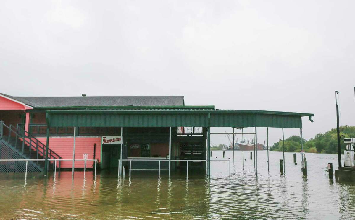 Water laps up to The Hurricane, a bar in Oak Island, Texas on Tuesday, Sept. 22, 2020.