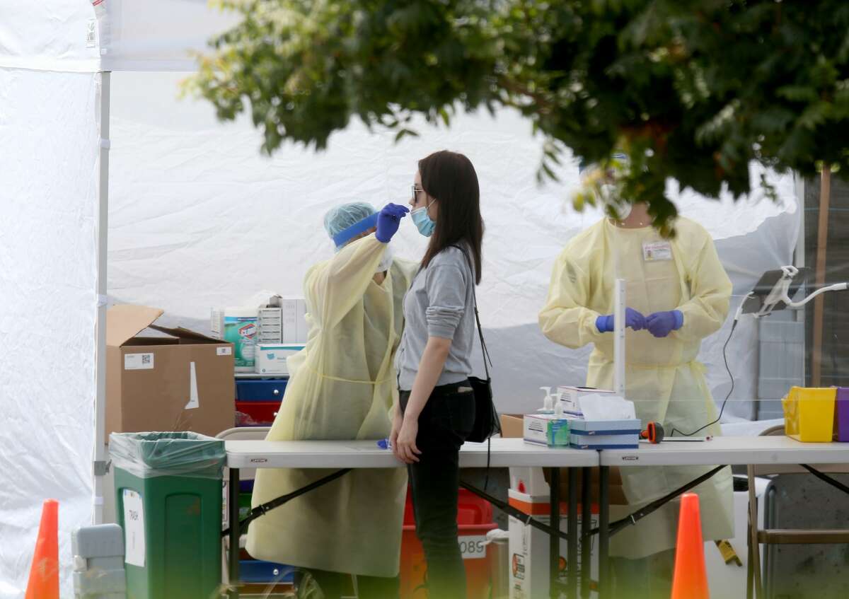 A woman gets tested at a Covid-19 test site at Madison Park in downtown Oakland, Calif., on Tuesday, Sept. 15, 2020.