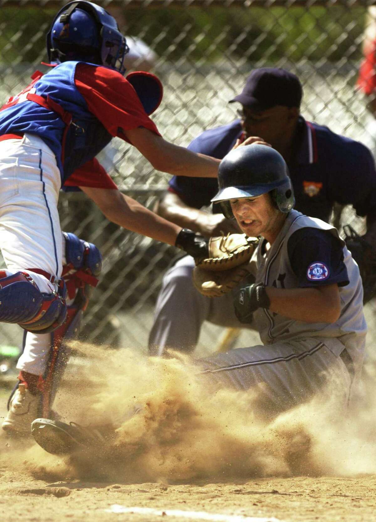 Norwalk’s Matt Harbilas arrives safely at home as Stamford catcher Kyle Foti makes a late tag in a 2004 Babe Ruth game.