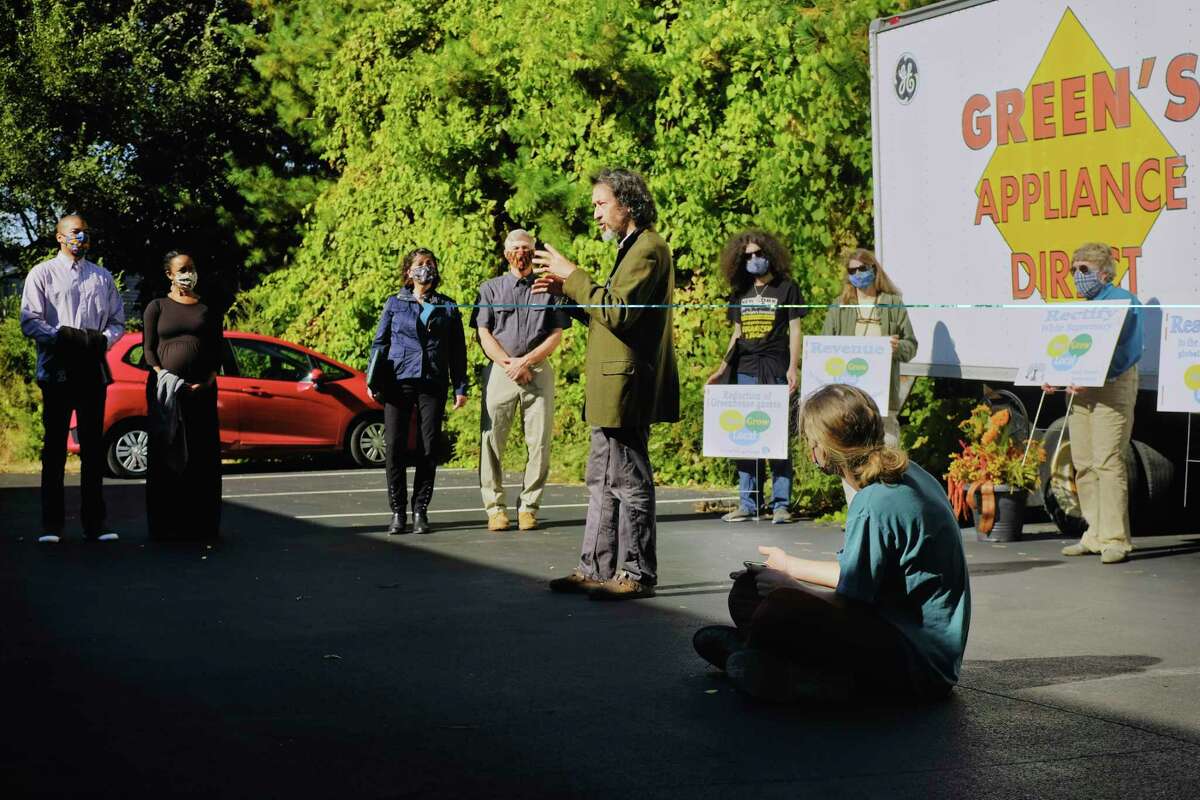 Jack Magai, center, a member of More Trees Arborist Collective, speaks at a press conference to launch the Buy Local, Grow Local directory outside of Green's appliance store on Tuesday, Oct. 6, 2020, in Latham, N.Y. Green's is the first appliance and furniture retail business in the state to be L.E.E.D. certified. (Paul Buckowski/Times Union)