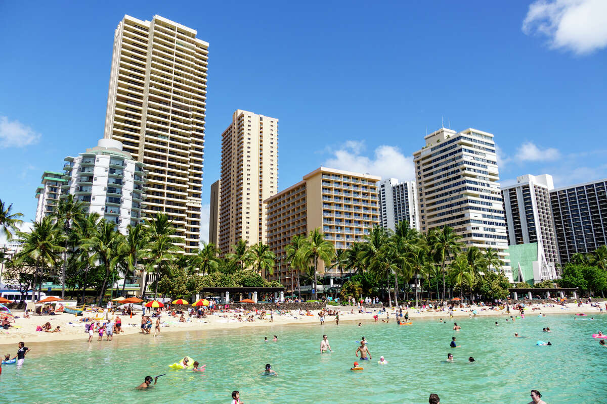 Sunbathers and swimmers at Waikiki Beach on the island of Oahu.