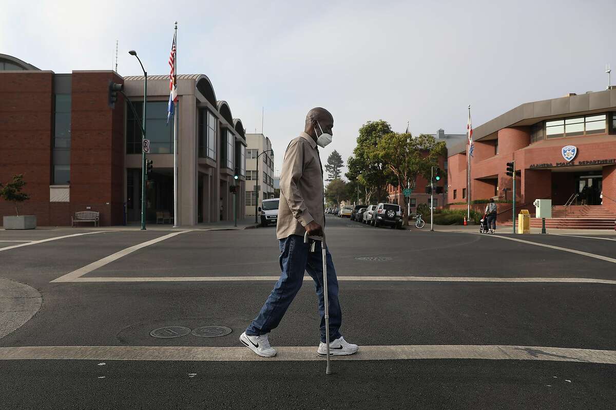 2020年10月5日星期一，加利福尼亚州阿拉米达，来自阿拉米达的托尼·阿姆斯特朗每天在他的社区散步时穿过橡树街。