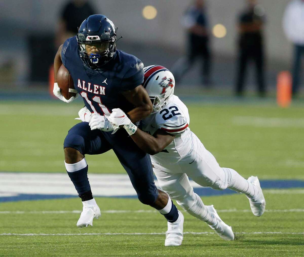 Allen's Jordan Johnson (11) is brought down by Humble Atascocita's Davon Bacon (22) during a run play in the first quarter of play at Eagle Stadium in Allen, Texas on Friday, October 2, 2020. (Vernon Bryant/The Dallas Morning News)