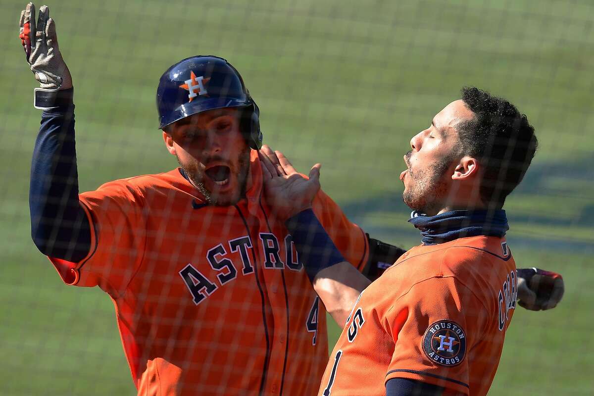 George Springer #4 of the Houston Astros celebrates a home run against the Oakland Athletics with Carlos Correa #1 during the fifth inning in Game Two of the American League Division Series at Dodger Stadium on October 06, 2020 in Los Angeles, California.