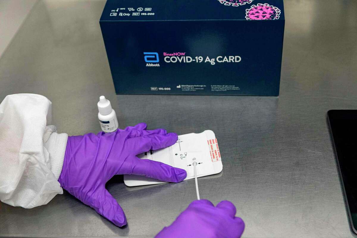 This handout photo obtained September 29, 2020 courtesy of Abbott, shows Abbott's BinaxNOW Covid-19 Ag Card, a rapid, reliable, highly portable, and affordable tool for detecting active coronavirus infections at massive scale. - Abbott announced on August 26, 2020, that the US Food and Drug Administration (FDA) has issued Emergency Use Authorization (EUA) for its BinaxNOW COVID-19 Ag Card rapid test for detection of COVID-19 infection. Abbott will sell this test for USD $5. It is highly portable (about the size of a credit card), affordable and provides results in 15 minutes.