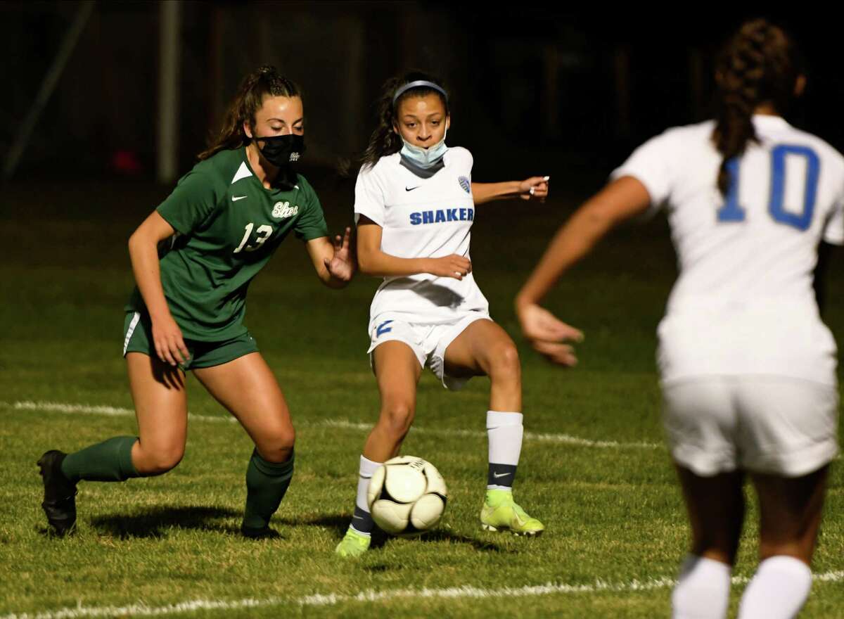 Shen's Sophia Demura looks on as Shaker's Mayah Wheeler passes the ball to a teammate during a game Tuesday, Oct. 6, 2020, in Clifton Park(Jenn March, Special to the Times Union)