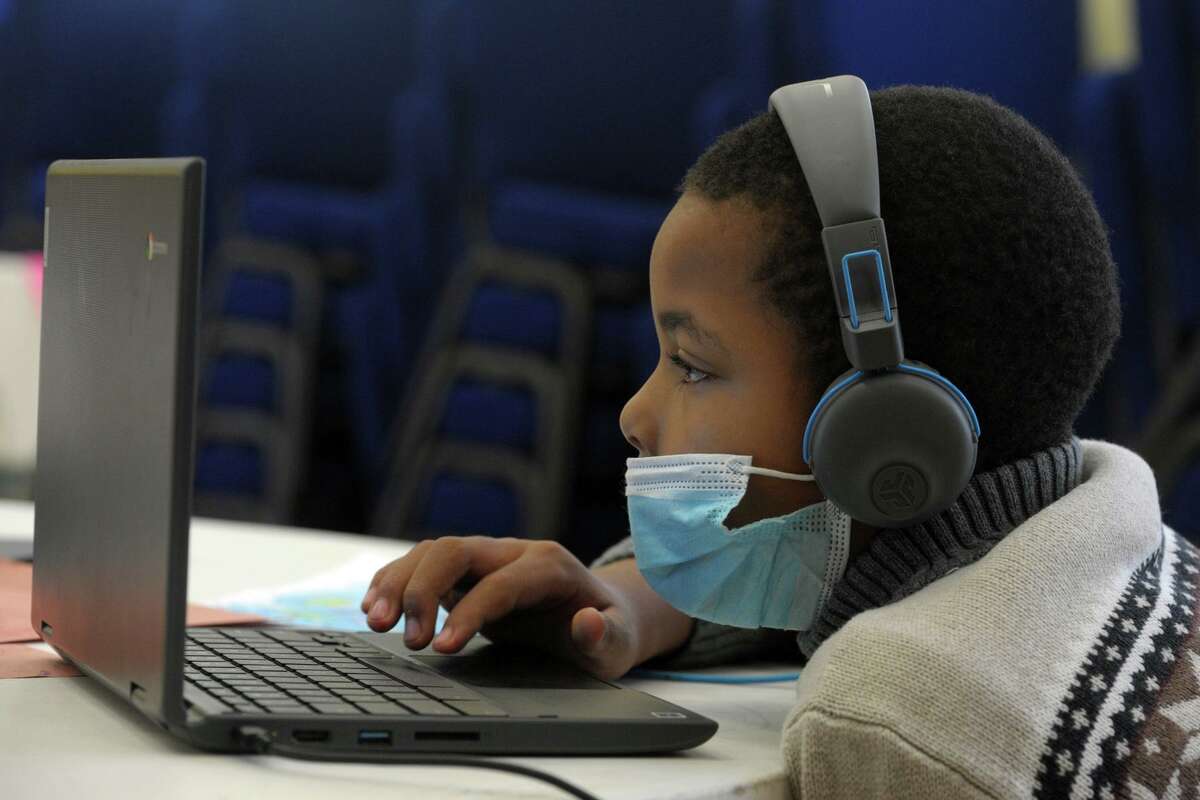 Fourth grader Jaylen Carver works on a laptop computer at the community learning hub at First Cavalry Baptist Church, in New Haven, Conn. Oct. 6, 2020.