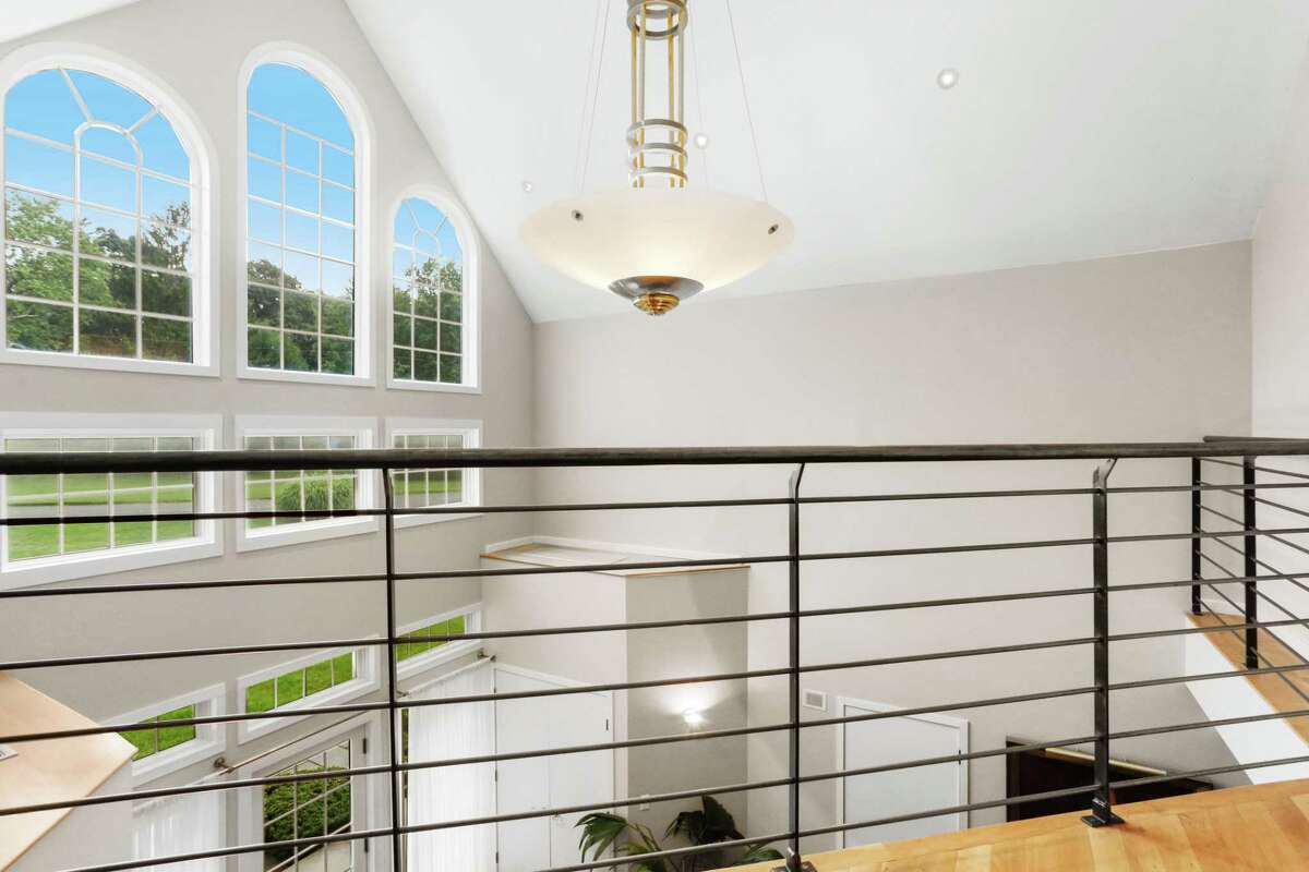 The two-plus-story foyer features a contemporary light fixture. In one wing of the house there are three bedrooms on the main level. Two of them share a hall bath and one is en suite. At the opposite end of the house there is a two-bedroom apartment that includes a kitchenette, sitting area with a sliding door to the porch and yard, and a separate entrance - a perfect in-law or au pair suite. For more information or to make an appointment to see the house contact Sheila Shupack of William Raveis Real Estate at 203-984-2494 or Sheila.shupack@raveis.com.