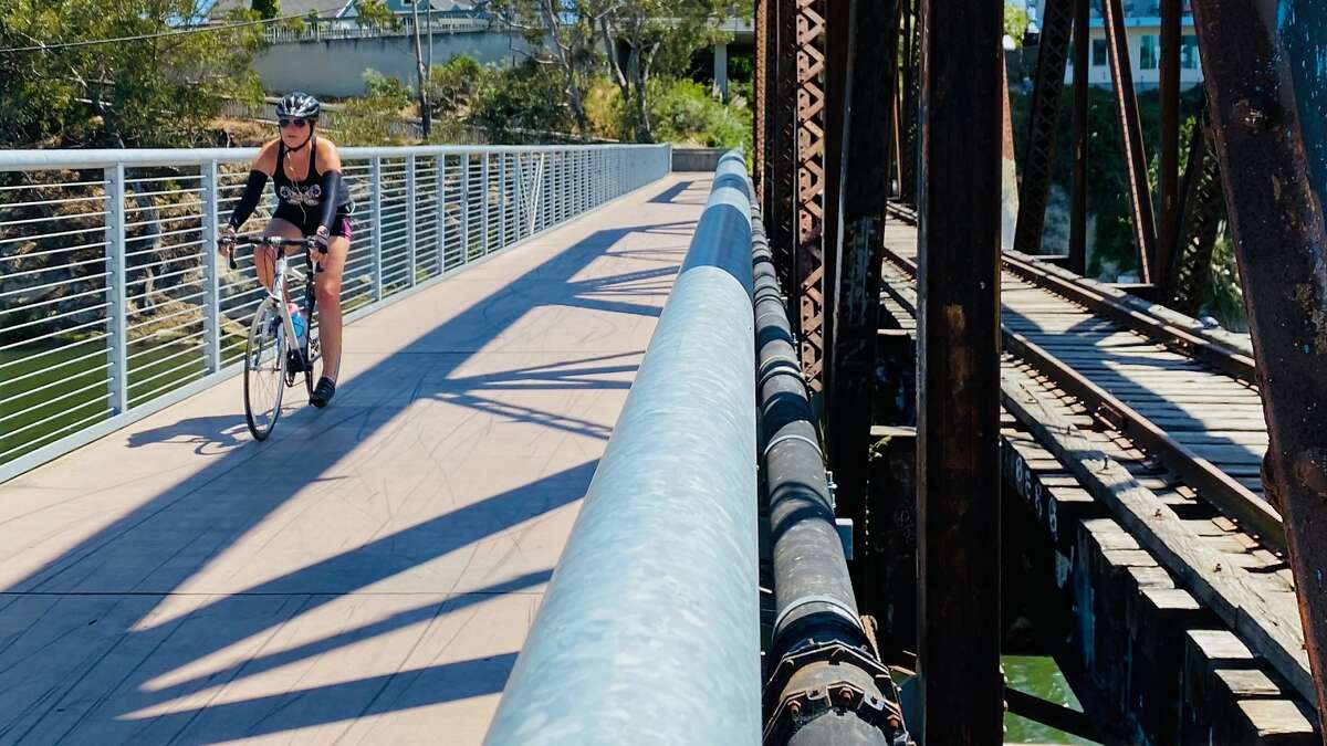 A cyclist crosses the San Lorenzo Bridge in Santa Cruz on the Coastal Rail Trail.