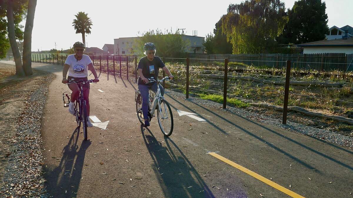 A pair of bicyclists enjoy the Coastal Rail Trail in Santa Cruz, where construction is underway to extend the trail.