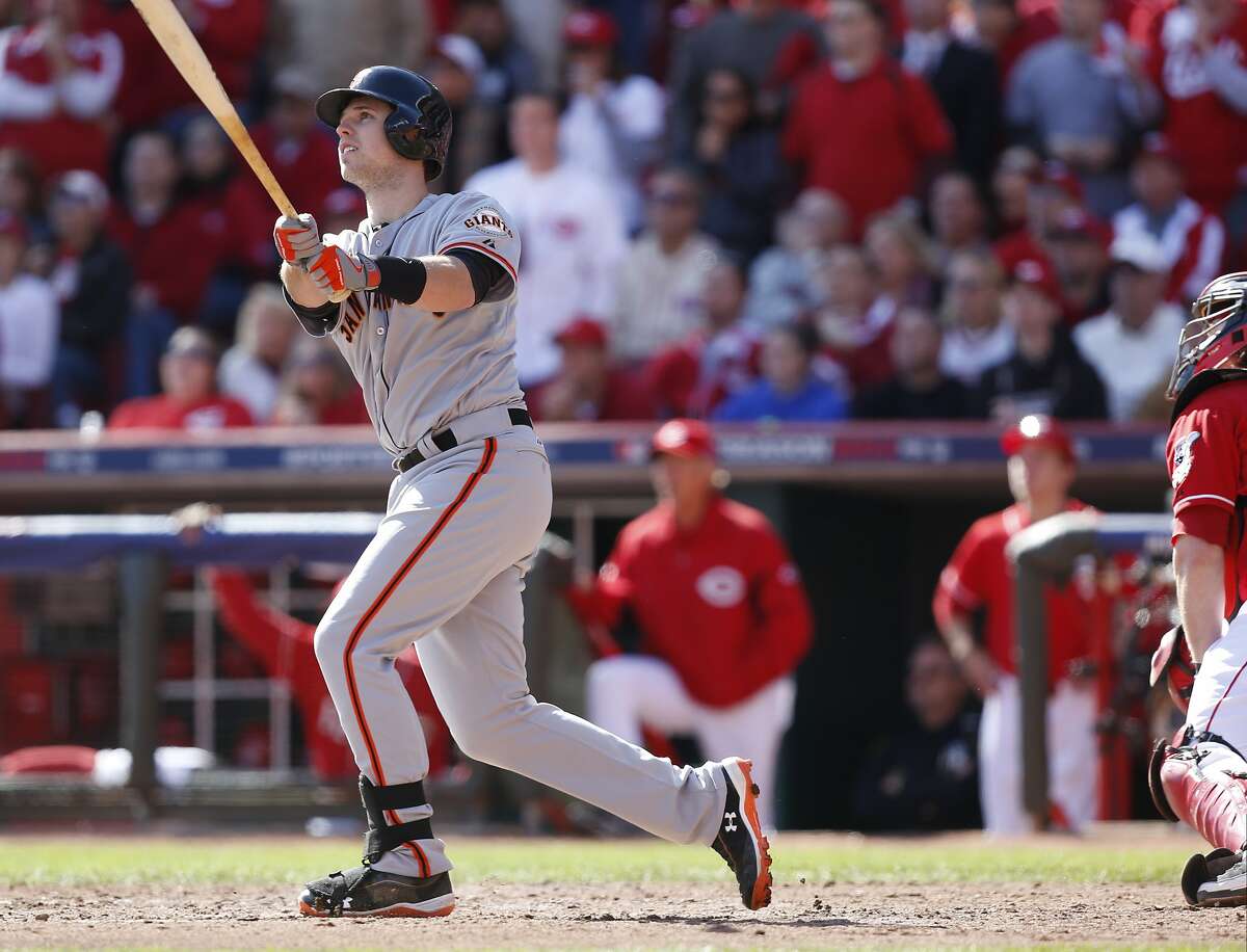 San Francisco Giants' Buster Posey hits a grand slam against the Cincinnati Reds in the fifth inning of Game 5 of the National League division baseball series, Thursday, Oct. 11, 2012, in Cincinnati. (AP Photo/David Kohl)