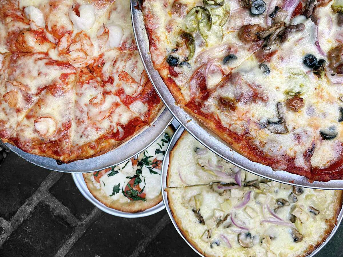 Pizza choices include, clockwise from top left, shrimp, Supreme, chicken Alfredo and margherita at Capparelli's on Main.