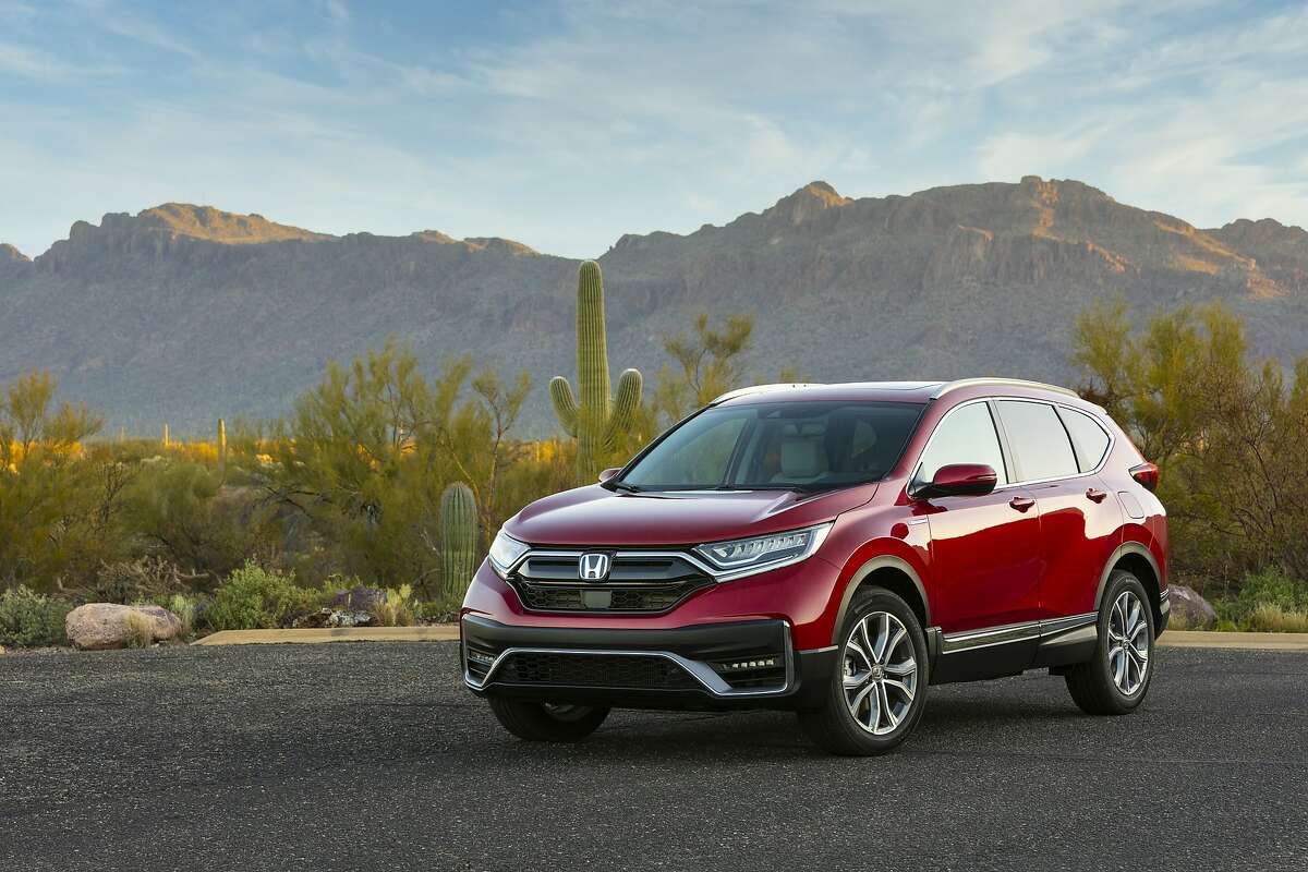 This photo provided by Honda shows the 2020 Honda CR-V Hybrid. The Honda CR-V Hybrid and Toyota RAV4 Hybrid are similar in fuel economy, power and practicality according to Edmunds. Each is a smart buy for a fuel-efficient SUV. (Wes Allison/Honda via AP)