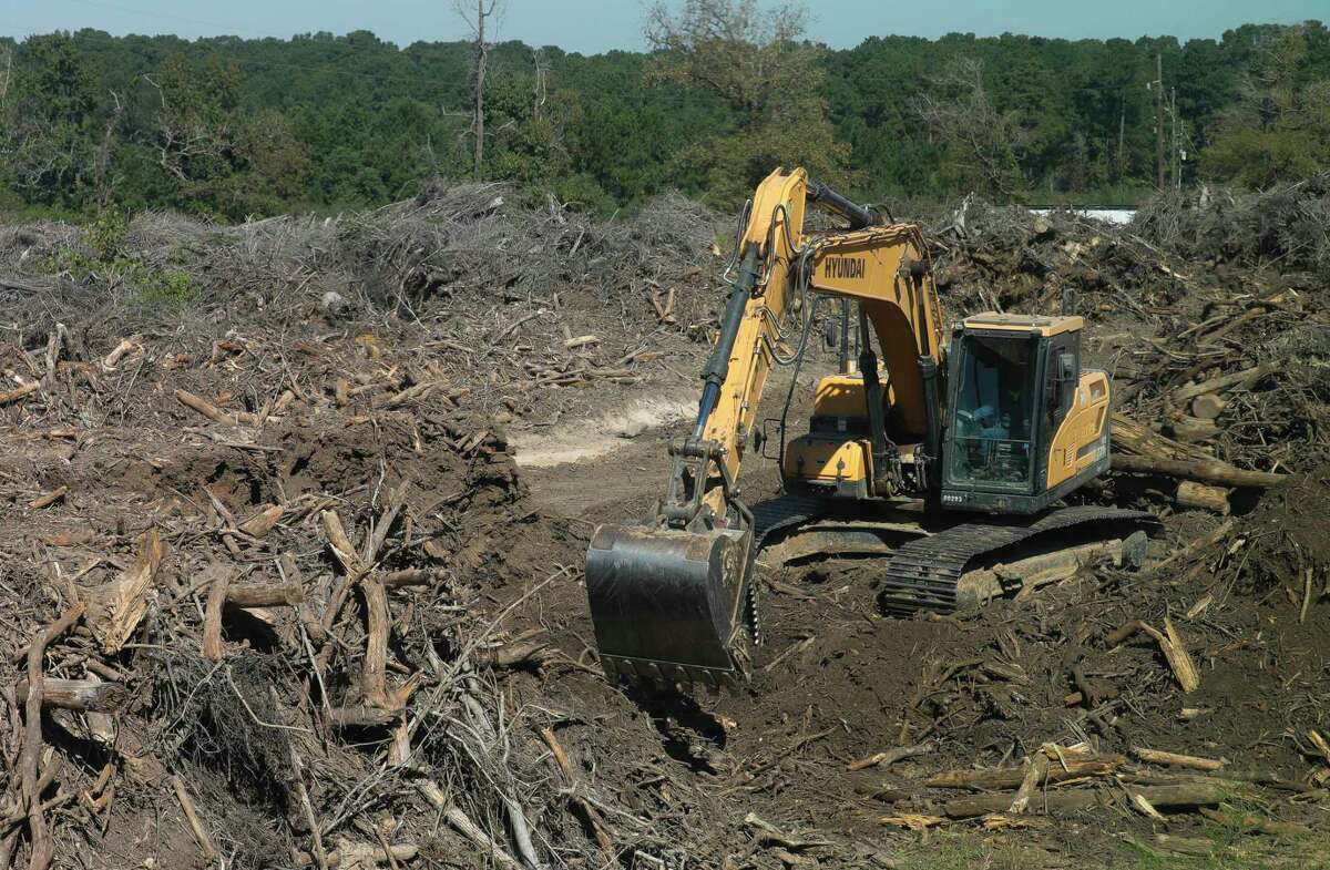 Construction equipment clears the massive dumpsite of long pile of trees and debris on land owned by Hasara Land Services in the Woodforest subdivision, Wednesday, Oct. 7, 2020, in Montgomery.