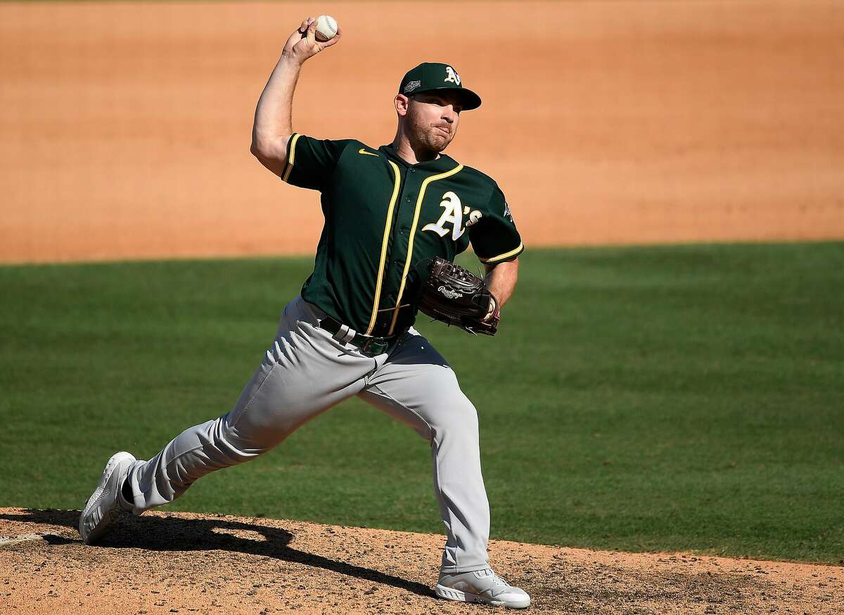 LOS ANGELES, CALIFORNIA - OCTOBER 07: Liam Hendriks #16 of the Oakland Athletics pitches against the Houston Astros during the seventh inning in Game Three of the American League Division Series at Dodger Stadium on October 07, 2020 in Los Angeles, California. (Photo by Kevork Djansezian/Getty Images)
