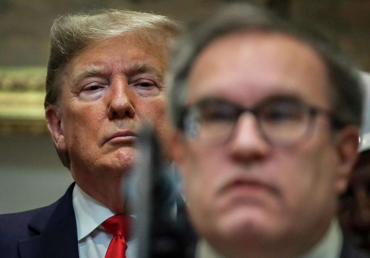 President Donald Trump looks on EPA Administrator Andrew Wheeler speaks during an event to unveil significant changes to the National Environmental Policy Act in January. Trump's deregulation efforts found their footing under Wheeler, a former lobbyist for energy companies.