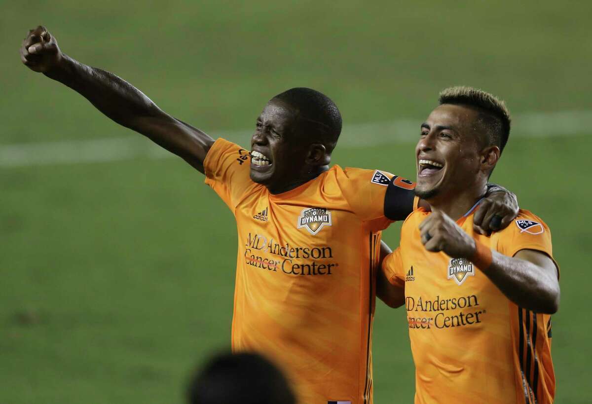 Houston Dynamo midfielder Darwin Ceren, right, celebrates his goal with penalty kick with Boniek Garcia (27) during the second half of a MLS match Wednesday, Oct. 7, 2020, at BBVA Stadium in Houston. Houston Dynamo defeated FC Dallas 2-0.