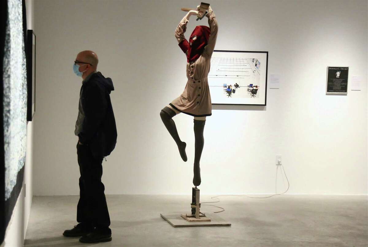 Tom Sladek of Westport examines a piece at the opening reception for the "World Peace" show at MoCA Westport on Wednesday, Oct. 7, 2020, in Westport, Conn.