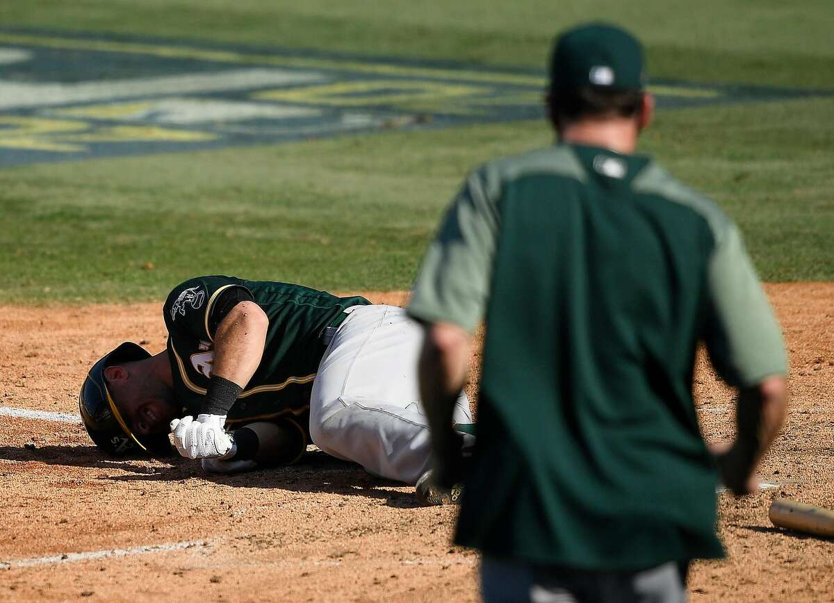 Tommy La Stella #3 of the Oakland Athletics reacts after being hit by a pitch by Brooks Raley #58 of the Houston Astros during the eighth inning in Game Three of the American League Division Series at Dodger Stadium on October 07, 2020 in Los Angeles, California.