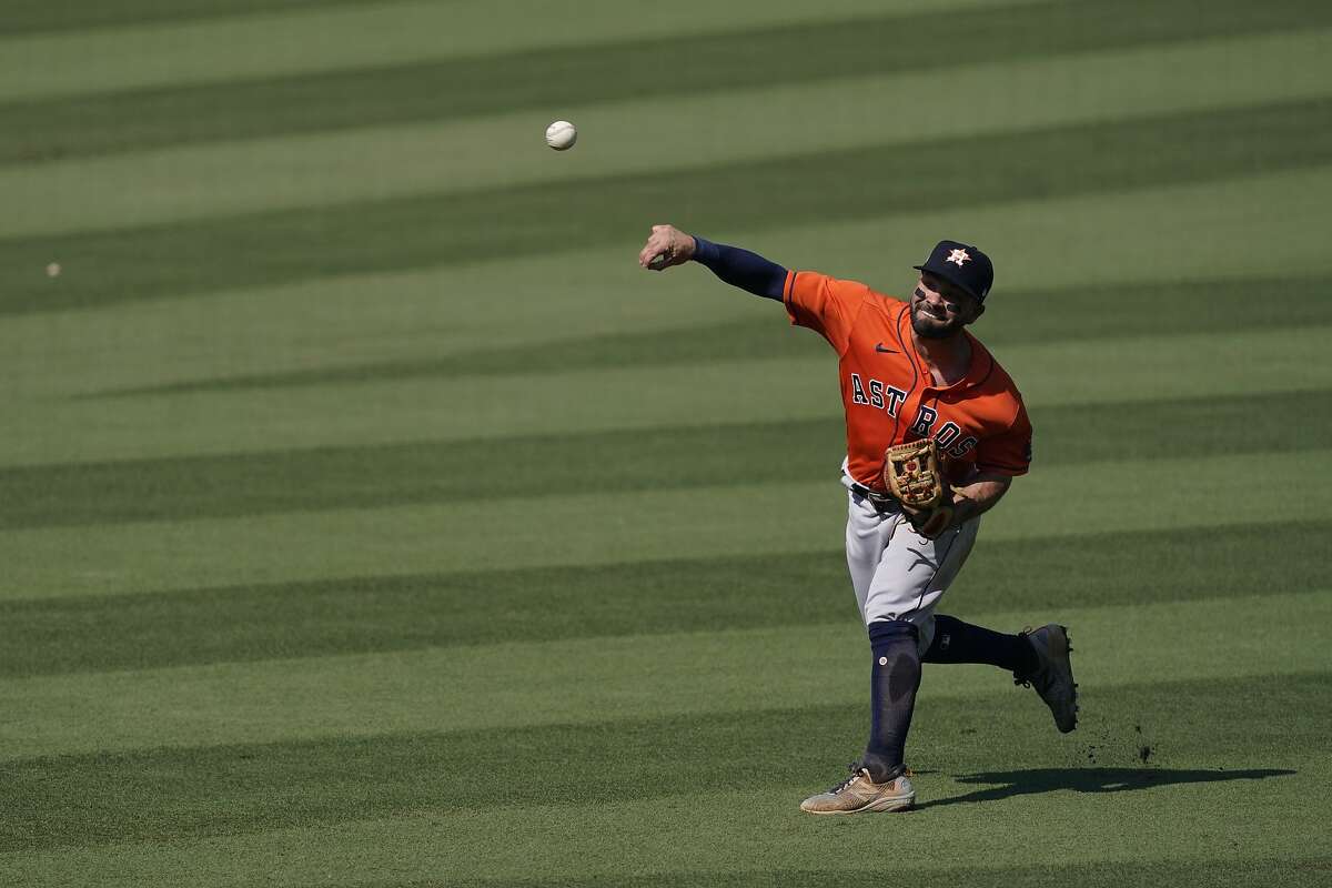Houston Astros second baseman Jose Altuve throws the ball to the infield during Game 2 of a baseball American League Division Series against the Oakland Athletics in Los Angeles, Tuesday, Oct. 6, 2020.