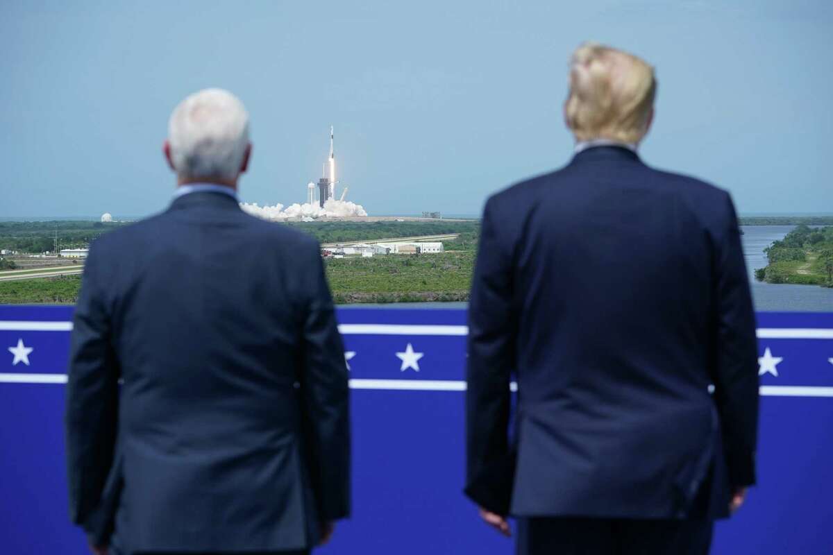 U.S. Vice President Mike Pence and U.S. President Donald Trump watch the SpaceX Falcon 9 rocket carrying the SpaceX Crew Dragon capsule, with astronauts Bob Behnken and Doug Hurley, lift off from Kennedy Space Center in Florida on May 30, 2020.