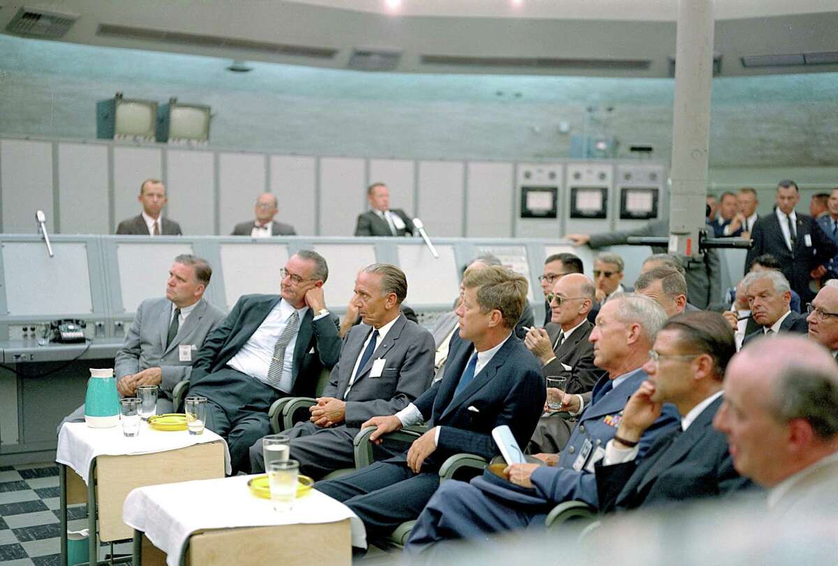 In this photograph from 1962, President John F. Kennedy attends a briefing given by Major Rocco Petrone during a tour of Blockhouse 34 at the Cape Canaveral Missile Test Annex. Also in attendance are Vice President Lyndon Johnson and Secretary of Defense Robert McNamara. The center was renamed in honor of Kennedy, the nation's 35th president, following his death. His vision to land astronauts on the moon within that decade inspired and challenged the agency.