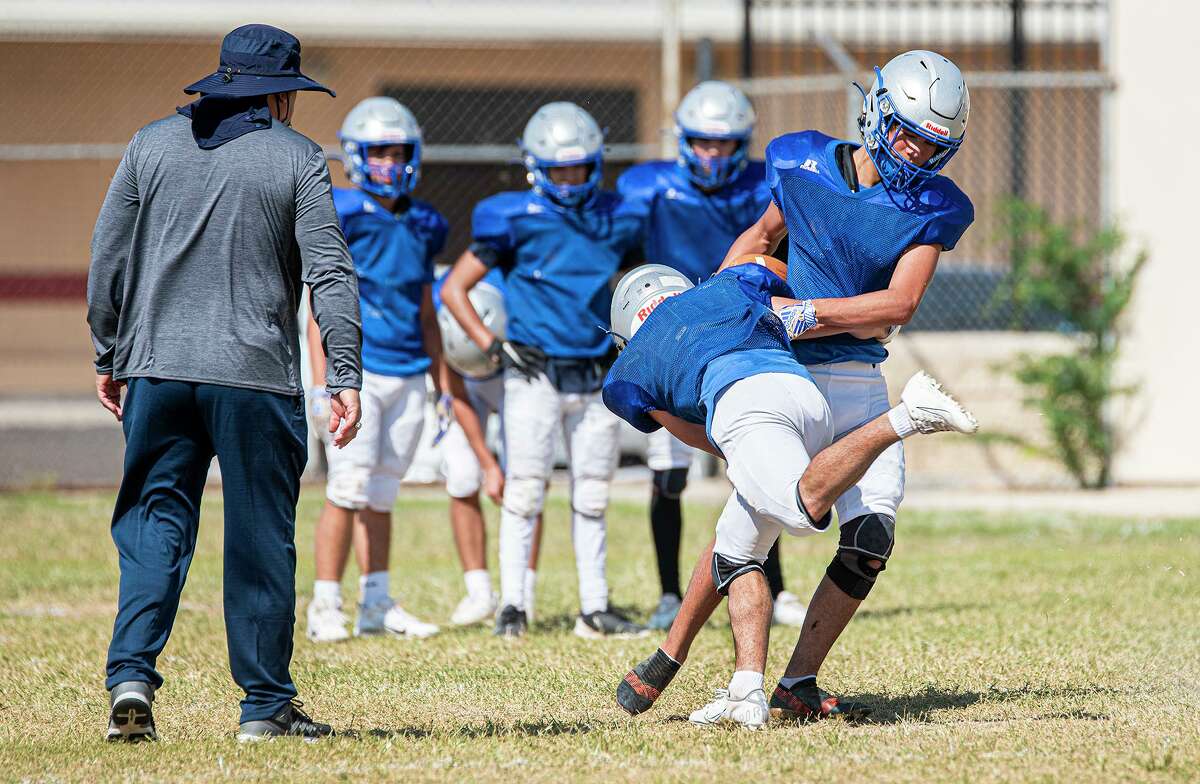 St. Augustine is pictured practicing before its first-ever football game.