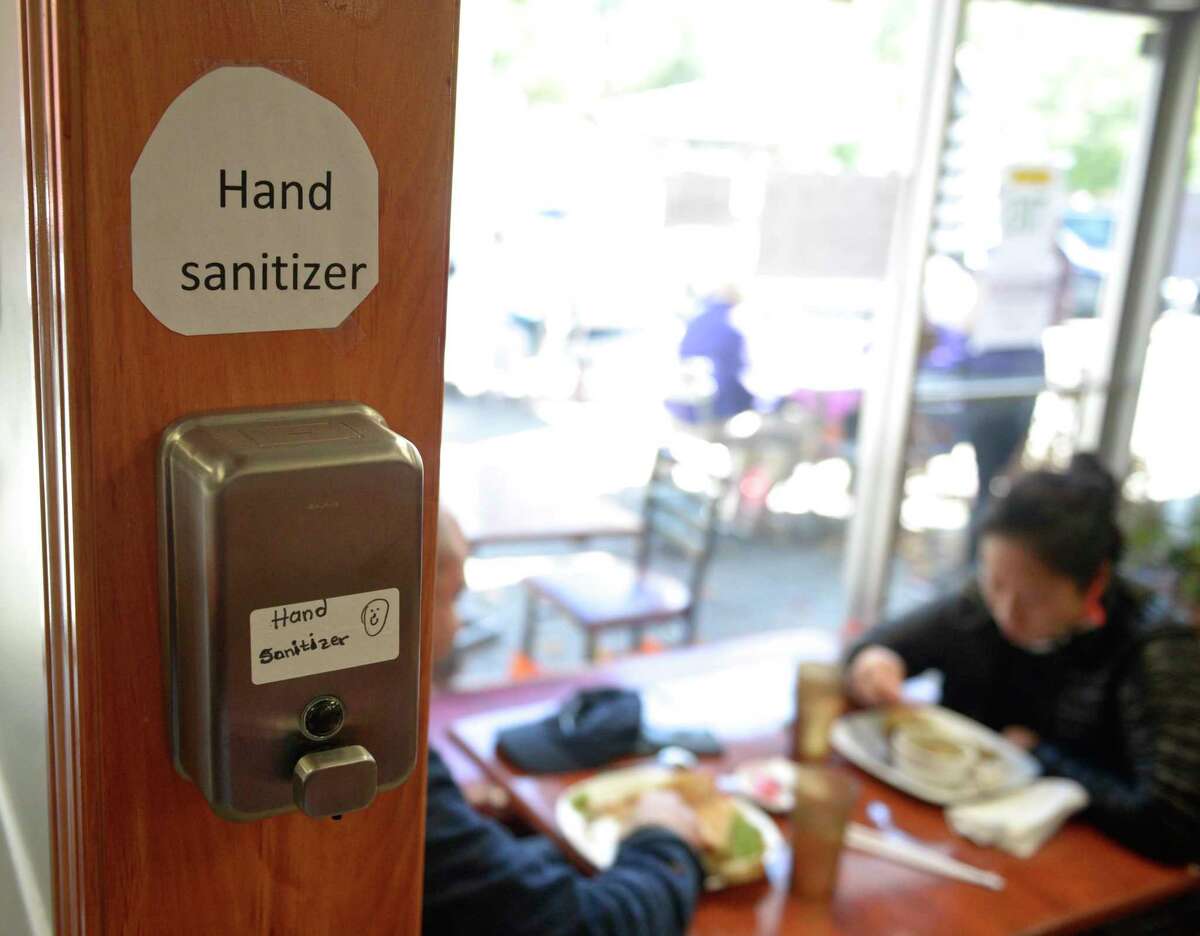 A hand sanitizer dispenser available at Johana's restaurant on Oct. 8 in New Milford.
