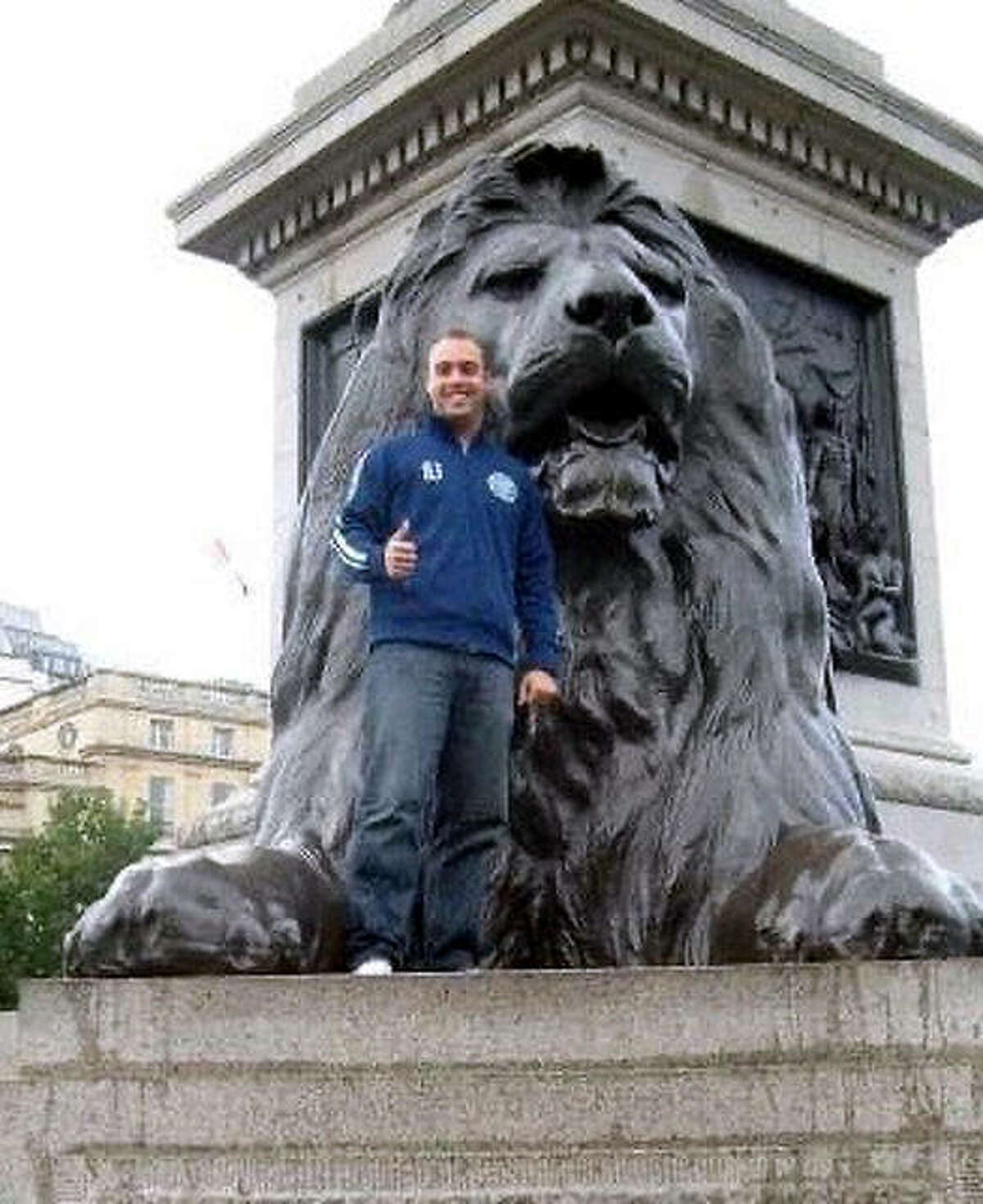 Jesse Daniels, the new girls soccer coach at East Alton-Wood River High, poses with a lion statue at Trafalgar Square in London in 2008. Daniels, who spent two years working in England as a teacher, said it was during that time he developed a new-found appreciation for soccer and learned plenty of new things about a game he thought he already knew a lot about.