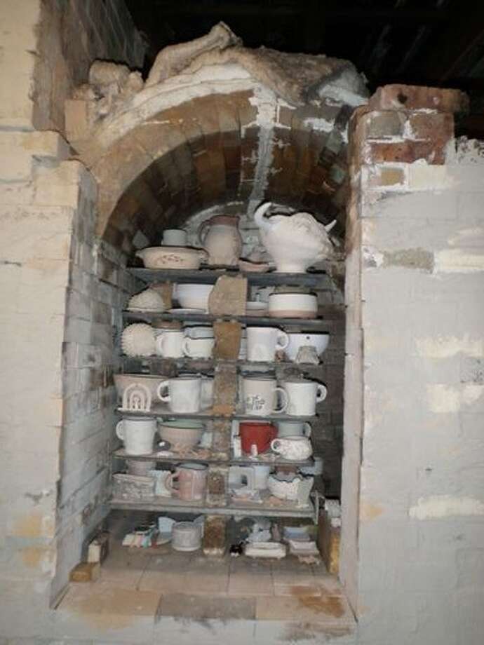 The kiln is stacked with pottery before being lit. The artists will retrieve their fired pieces after the kiln cools down. Photo: Photo Provided