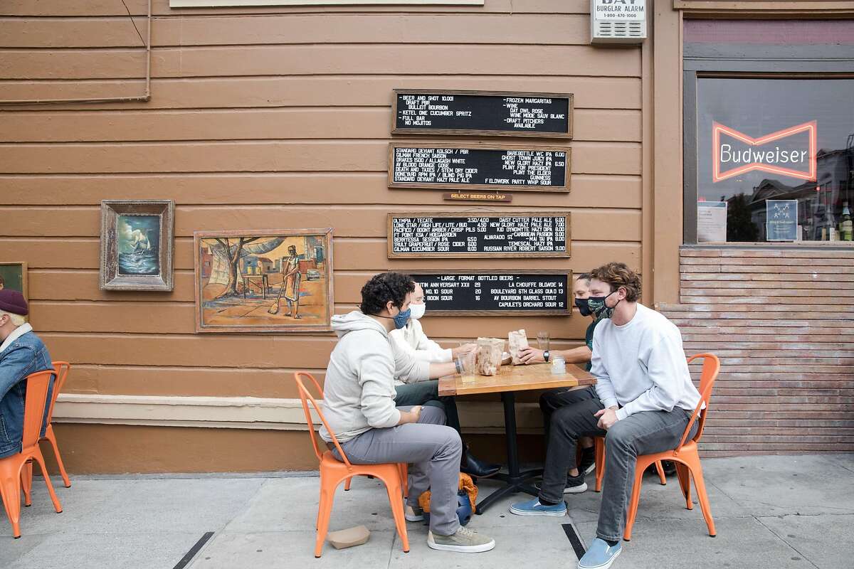 Patrons dine and have drinks outside The Page bar on the sidewalk and parklet seating in San Francisco on Oct. 8, 2020.