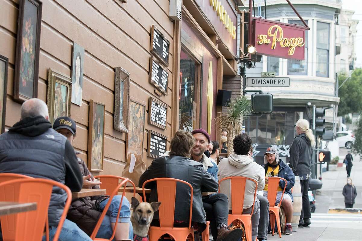 Patrons dine and have drinks outside the Page Bar on the sidewalk and parklet seating in San Francisco on Oct. 8, 2020. On Dec. 6, San Francisco shut down outdoor dining once again.