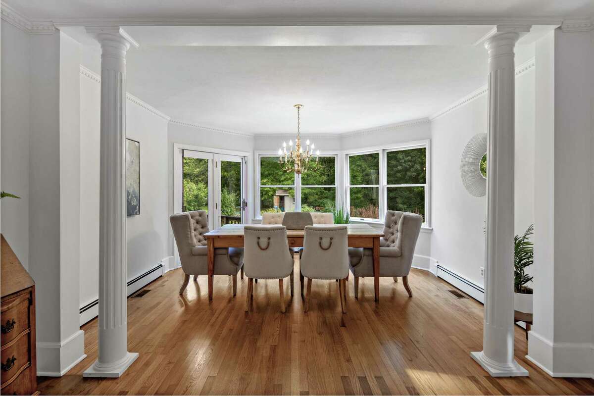 In the dining room there is a wall of windows, French doors to the deck and yard. Flexibility really is a key descriptor for this house with