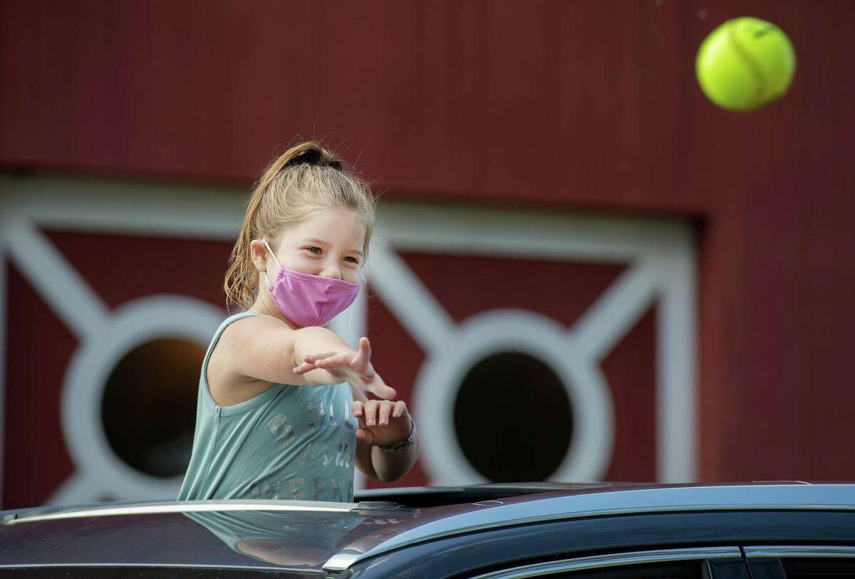 Maicey Streisand, 6, of Wilton throws a ball at the dunk tank.