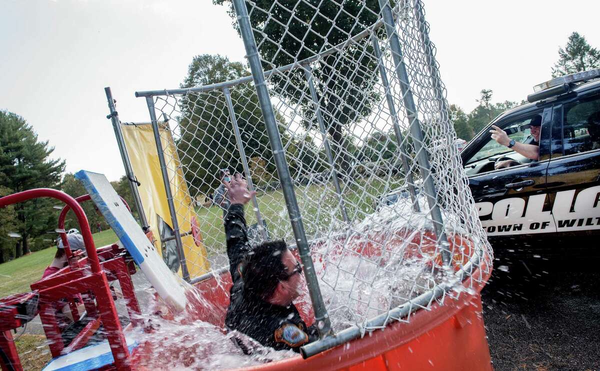 Wilton K9 Officer Patenaude gets dunked at Ambler Farm Day on Sunday, Oct. 4.