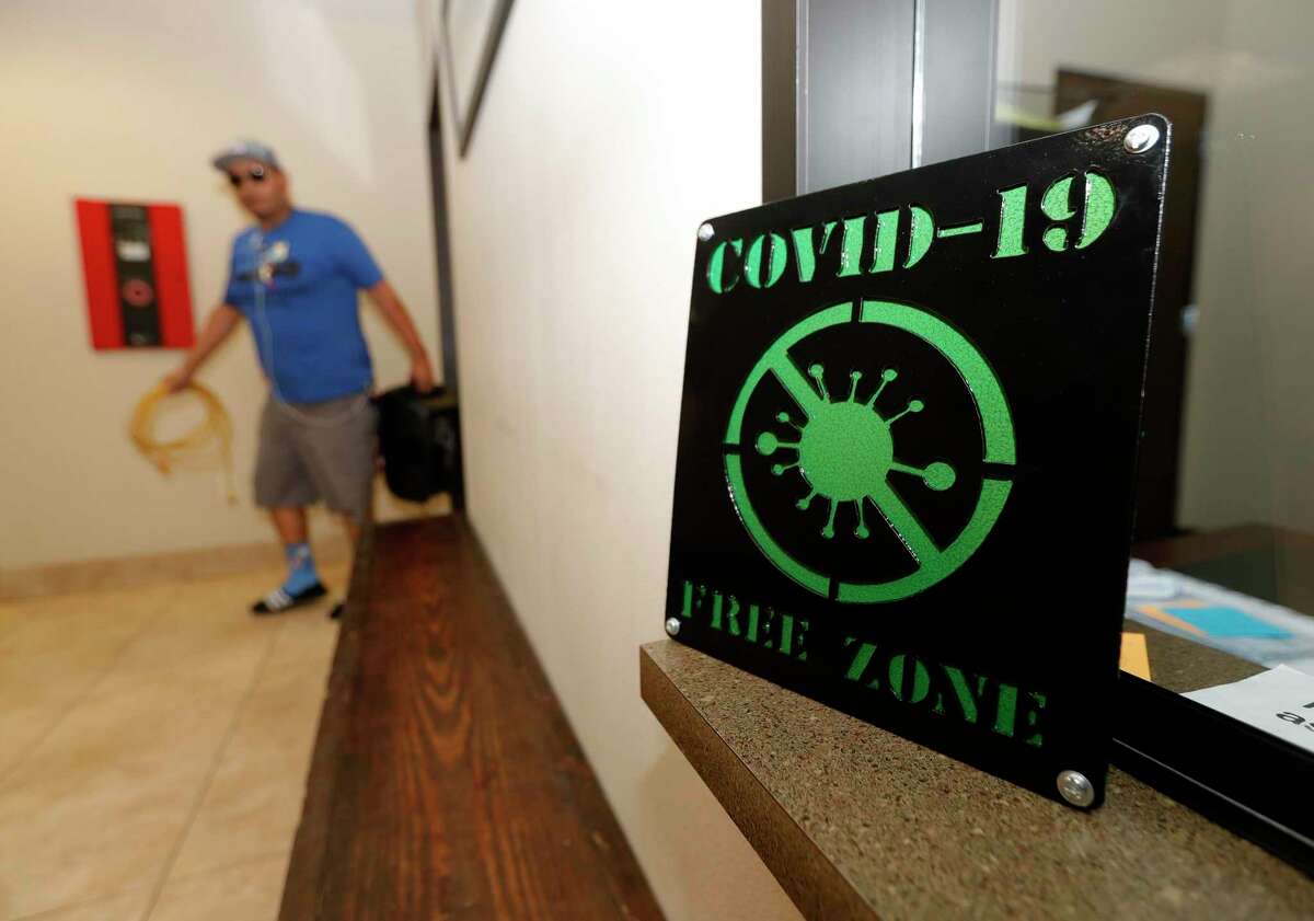 A COVID-19 sign is seen at Southern Star Brewing, Friday, April 3, 2020, in Conroe.
