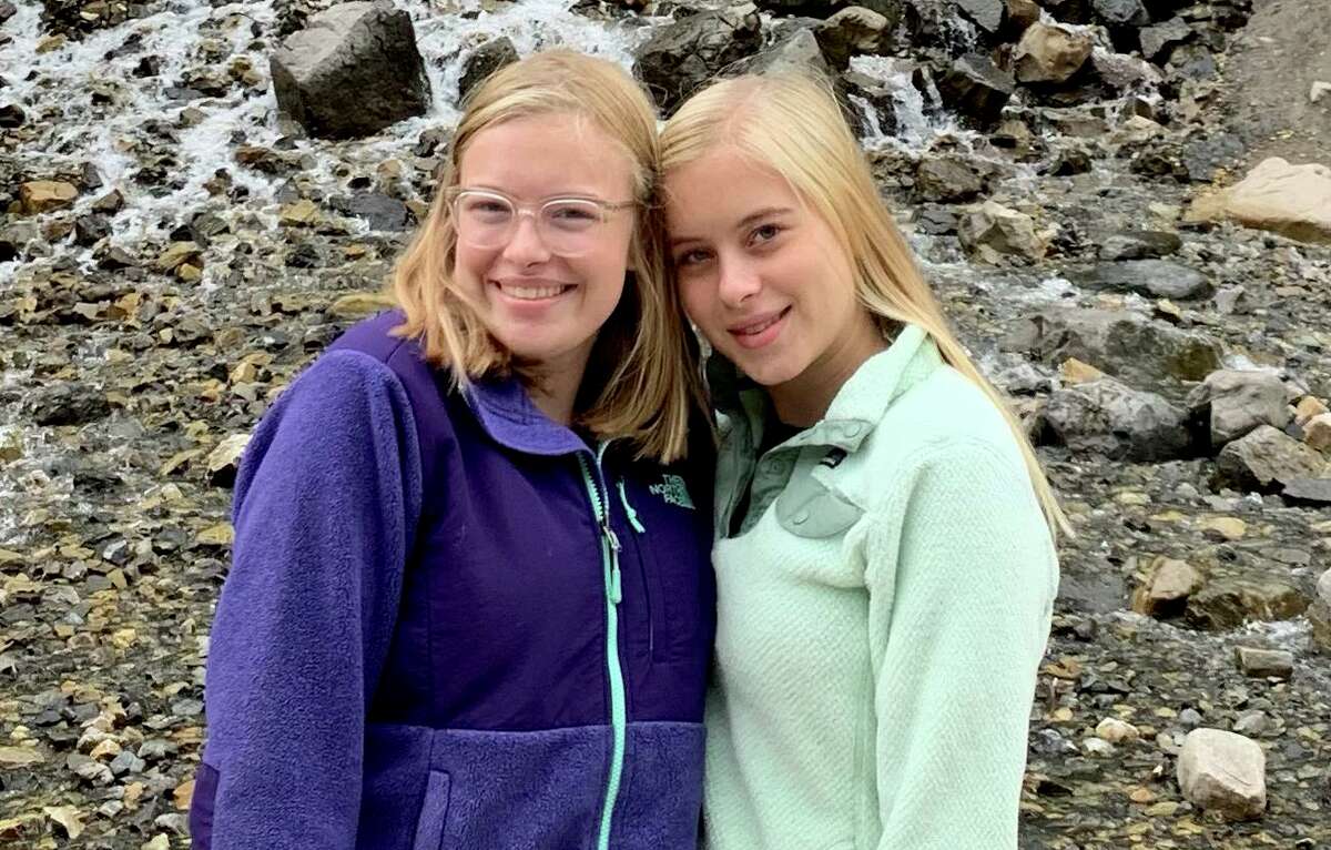 M.K. Blum, right, poses with her sister Brinkley. M.K. is working as a co-facilitator in a new Abilis program that aims to support children who have siblings with a disability.