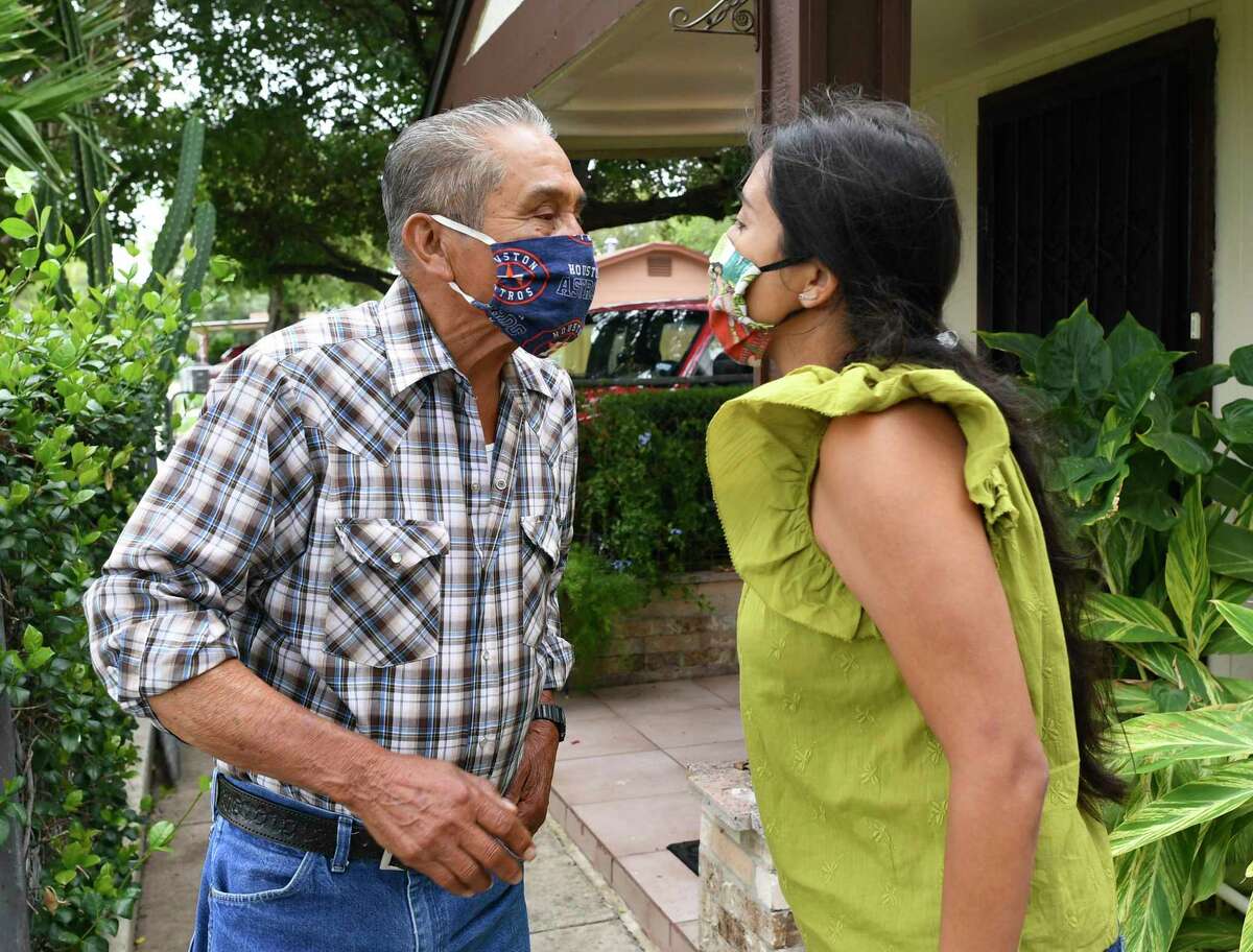 Rocha Garcia gives her father, Valeriano Rocha, a masked air kiss. An only child, the councilwoman takes care of her elderly parents.