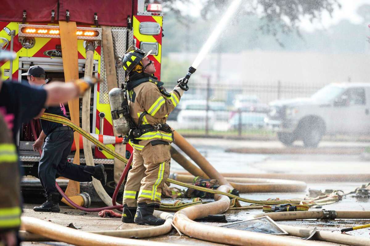 Firefighters from Spring, Ponderosa, Little York, Klein, and The Woodlands Fire Departments battle a multi-alarm fire at the Motel 6 on Cypresswood CT in North Harris County Oct. 9, 2019.
