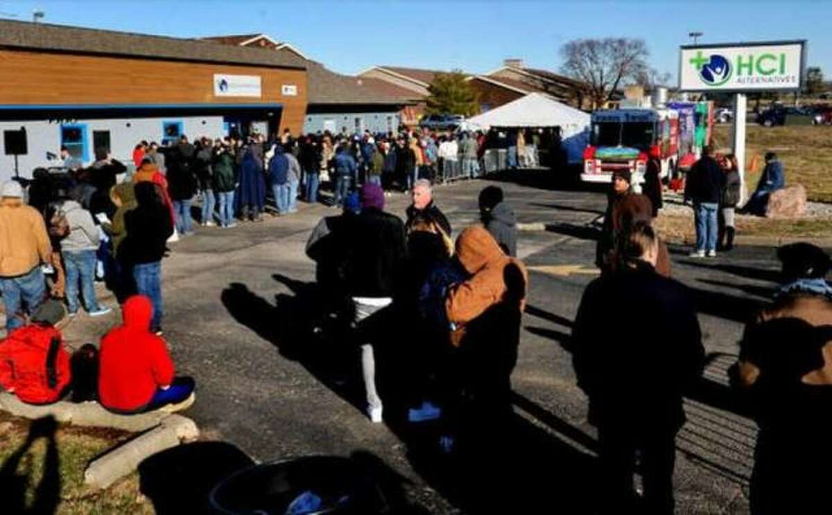 In this Jan. 1, 2020 file photo, customers lined up in front of HCI Alternatives (now Illinois Supply & Provisions) in Collinsville to purchase cannabis legally.