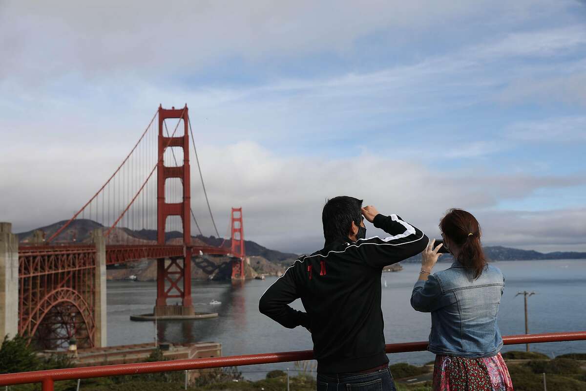 Tran Nguyen of San Francisco and Meriam Rumai of Oklahoma take in the view of the Golden Gate Bridge and San Francisco Bay as Nguyen takes Rumai on a tour of San Francisco late last year.
