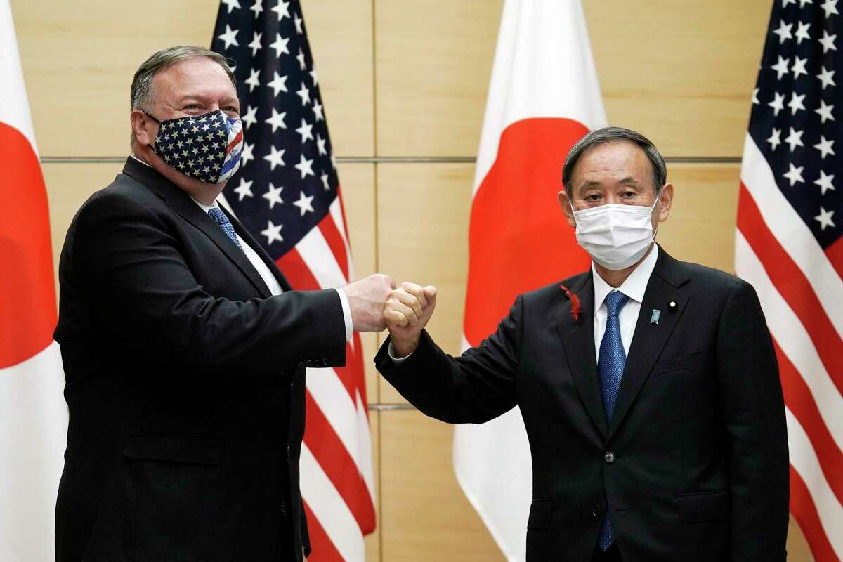 U.S. Secretary of State Mike Pompeo, left, greets Japan's Prime Minister Yoshihide Suga at the prime minister's office in Tokyo on Tuesday. One reader wonders why the U.S. didn’t stick with the Trans-Pacific Partnership.
