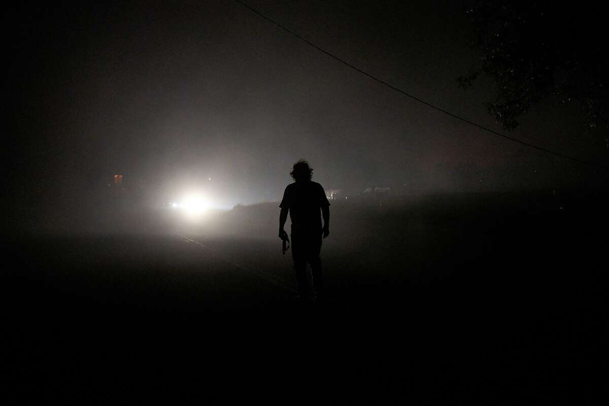 Homeowner Tom Smith walks away from the Zogg Fire near his home on Platina Road in Igo, on Sept. 27.