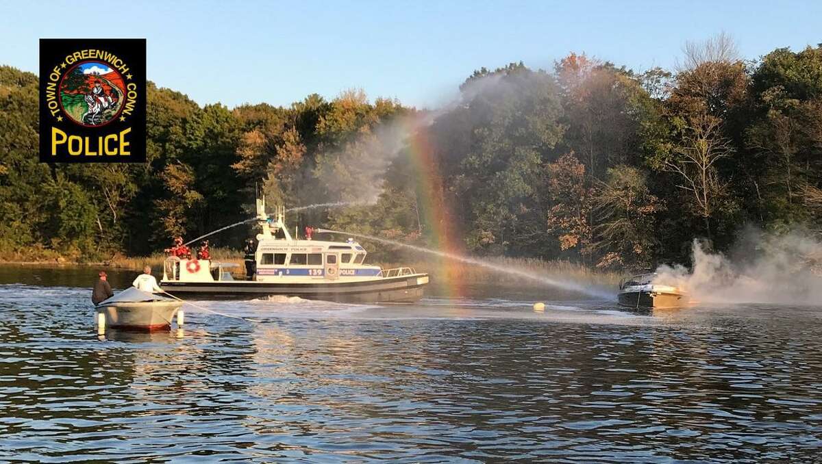 Firefighters battle a boat fire in the Cos Cob area on Friday.
