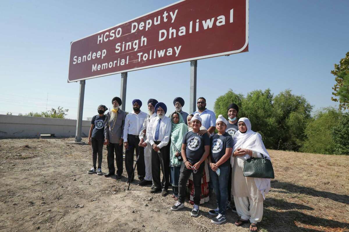 The Dhaliwal family have their photo taken during the renaming of a portion of Beltway 8 (between 249 and 290) on the Harris County Toll Road Authority in northwest Harris County in honor of Sheriff Deputy Sandeep Dhaliwal ceremony Tuesday, Oct. 6, 2020, in Houston.