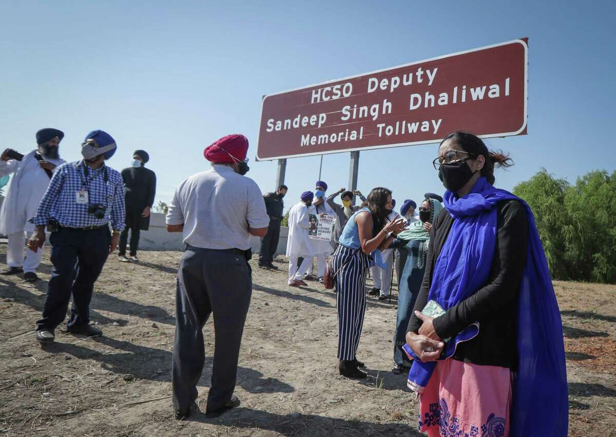 Sheriff Deputy Sandeep Dhaliwal's widow Harvinder Kaur pauses during the renaming of a portion of Beltway 8 (between 249 and 290) on the Harris County Toll Road Authority in northwest Harris County in honor of Dhaliwal Tuesday, Oct. 6, 2020, in Houston.