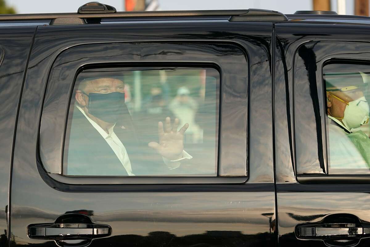 President Trump waves to supporters during his motorcade outside Walter Reed hospital in Bethesda, Md., last Sunday.